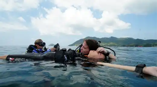 Rescue diver trainee performing a surface rescue during the React right & Rescue Diver Course in Koh Tao