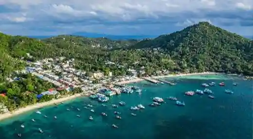 Aerial view of Koh Tao Thailand with Mae Haad village, the pier and dive boats anchored in the bay.