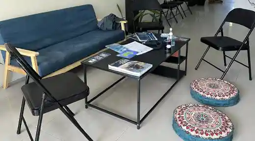 Three smiling fun divers wearing scuba gear on the Echo Divers boat in Koh Tao before a dive.