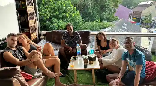 Group of guests relaxing and smiling together on the rooftop lounge at Echo Hostel Koh Tao Thailand.